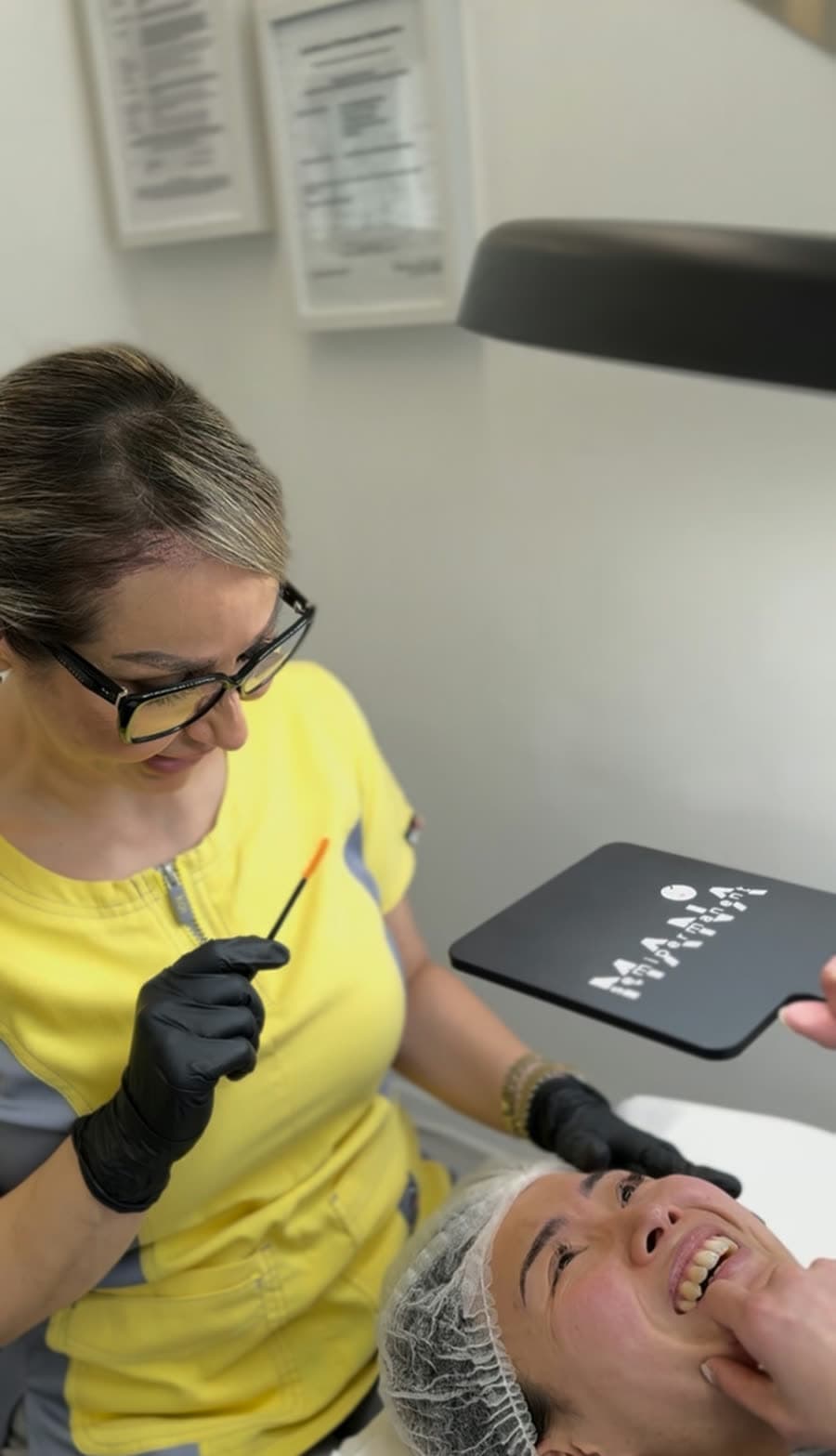 Mana Treating a Client's Brows Mana, founder of Mana Semipermanent, carrying out a brow treatment on a client at the studio in Jesmond, Newcastle upon Tyne.